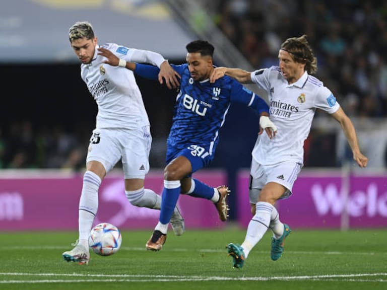 RABAT, MOROCCO - FEBRUARY 11: Salem Aldawsari of Al Hihal holds off Federico Valverde and Luka Modric of Real Madrid during the FIFA Club World Cup Morocco 2022 Final match between Real Madrid and Al Hilal at Prince Moulay Abdellah on February 11, 2023 in Rabat, Morocco. (Photo by David Ramos - FIFA/FIFA via Getty Images)