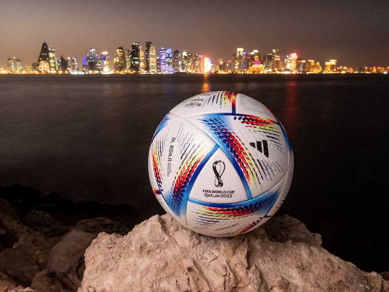 DOHA, QATAR - MARCH 31: In this photo illustration an official FIFA World Cup Qatar 2022 ball sits on display in front of the skyline of Doha ahead of the FIFA World Cup Qatar 2022 draw on March 31, 2022 in Doha, Qatar. (Photo by David Ramos/Getty Images)