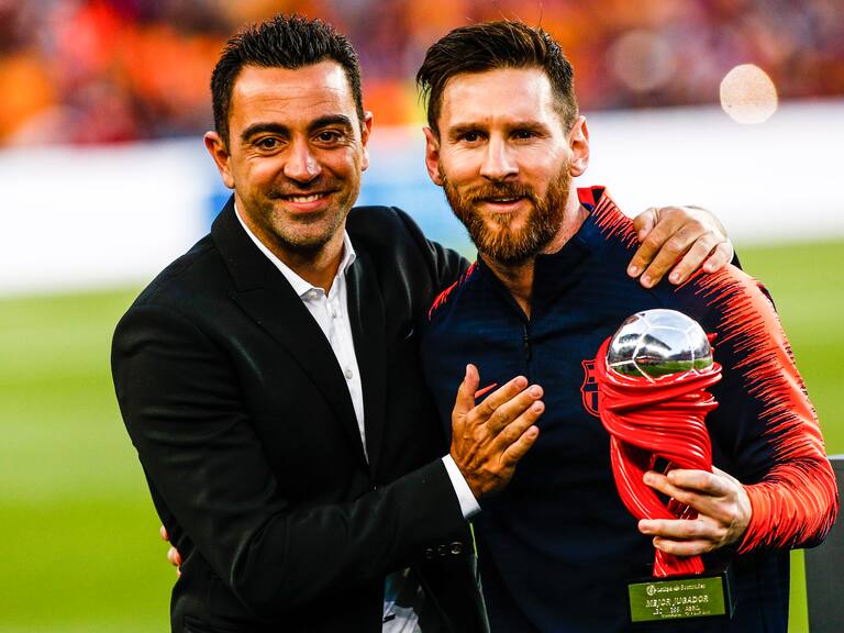 Xavi Hernandez and 10 Leo Messi from Argentina of FC Barcelona